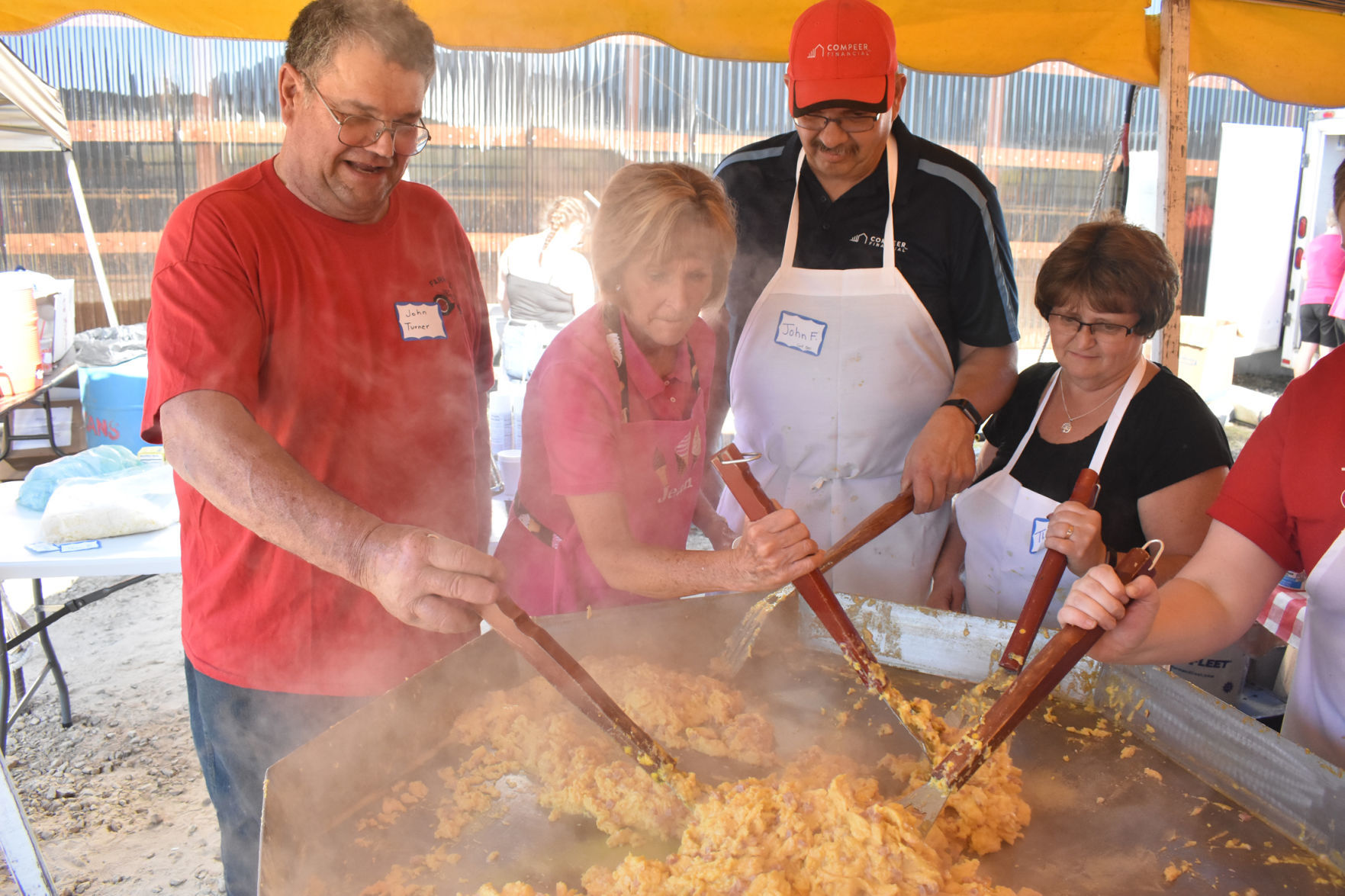 Volunteers cook a mountain of eggs